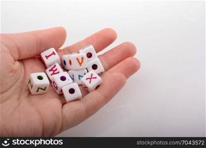 Colorful alphabet letter cubes in handon a white background