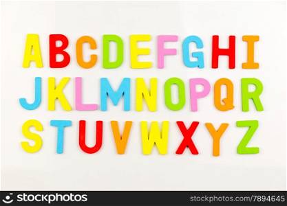 Colorful alphabet magnets on a whiteboard