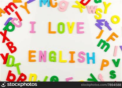 Colorful alphabet magnets on a whiteboard spelling I love English