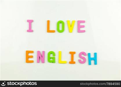 Colorful alphabet magnets on a whiteboard with phrase, I Love English