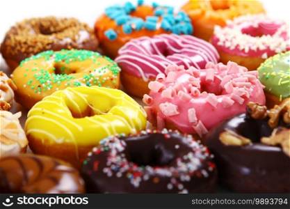 Colorful and tasty donuts on white background