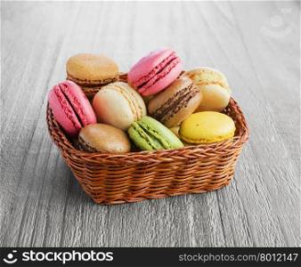 Colorful and tasty French Macaroons on the wicker basket
