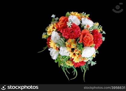 colorful artificial flower isolated on black background