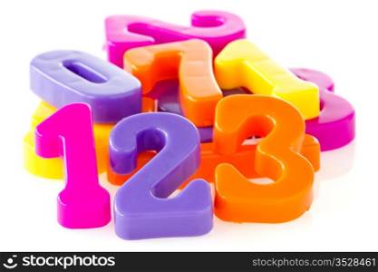 Colorful assorted plastic numbers over a white background