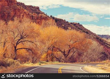 Colorful Autumn scene on countryside road in the sunny morning in Sierra Nevada area