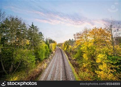 Colorful autumn scenery with a railroad track going through the landscape