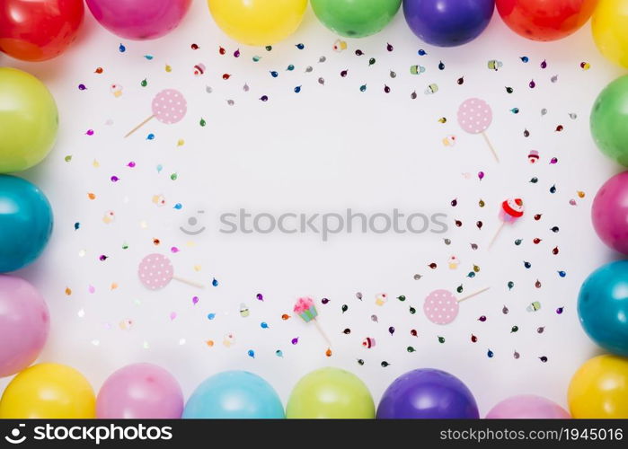 colorful balloons border with confetti props white background. High resolution photo. colorful balloons border with confetti props white background. High quality photo