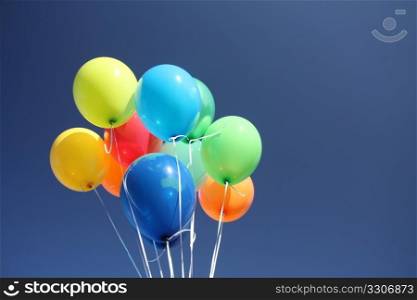 Colorful balloons dancing in a blue sky