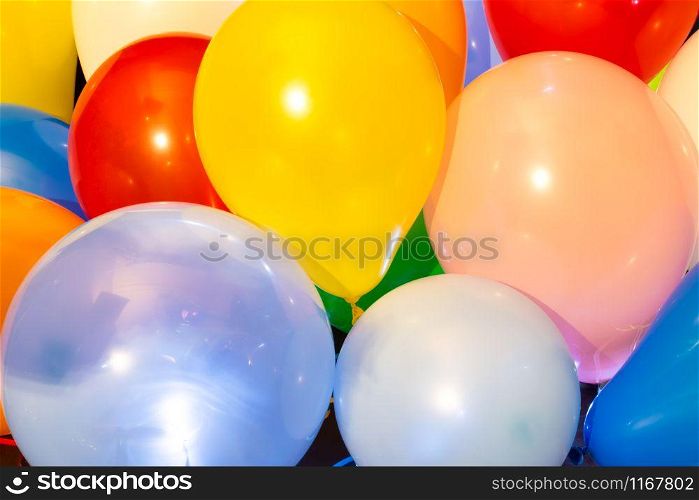 Colorful balloons illuminated with intern LED light against a dark background. Colorful balloons illuminated with LED against dark background