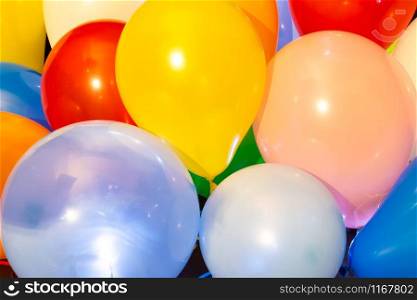 Colorful balloons illuminated with intern LED light against a dark background. Colorful balloons illuminated with LED against dark background