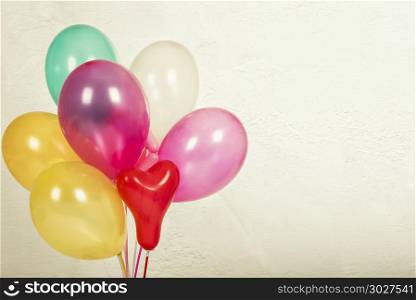 Colorful balloons with a retro vintage filter effect. The concep. Colorful balloons with a retro vintage filter effect. The concept of happy birthday in summer and wedding honeymoon party, anniversary and holiday background.