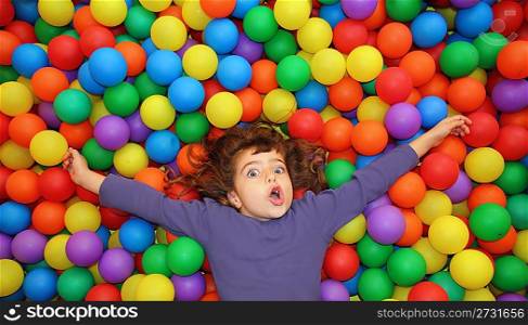 colorful balls funny park little girl lying gesturing happy