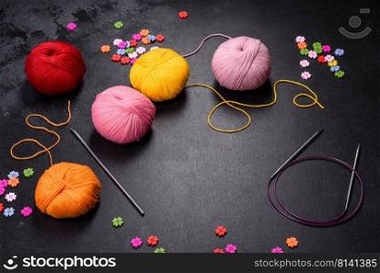 Colorful balls of wool on concrete table. Variety of yarn balls, view from above. Colorful balls of wool on concrete table. Variety of yarn balls