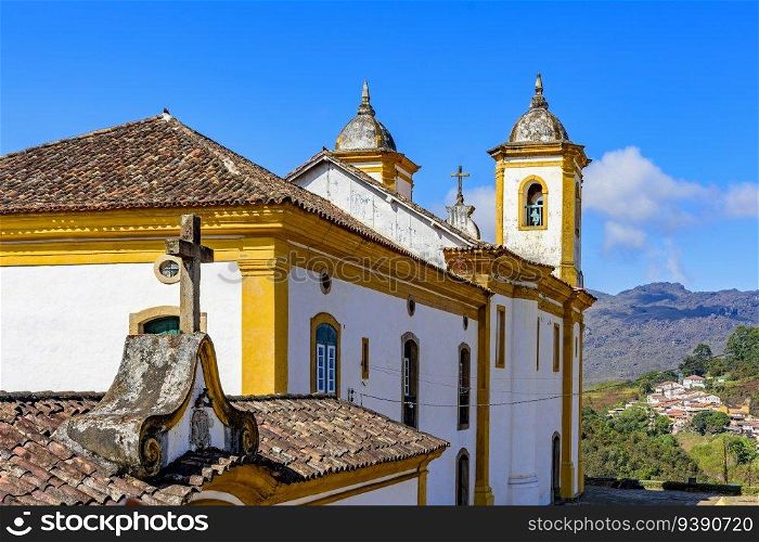 Colorful baroque church with mountains in the background in Ouro Preto city in Minas Gerais. Colorful baroque church with mountains