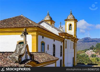 Colorful baroque church with mountains in the background in Ouro Preto city in Minas Gerais. Colorful baroque church with mountains
