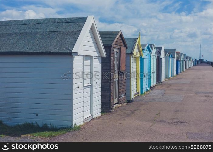 Colorful beach huts by the seaside on a sunny day