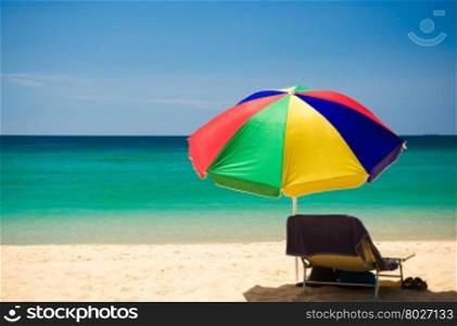 Colorful beach umbrella on the sandy beach on summer day