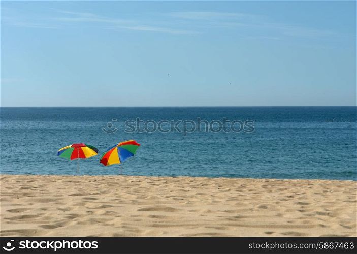 colorful beach umbrellas on the beach in the south of portugal