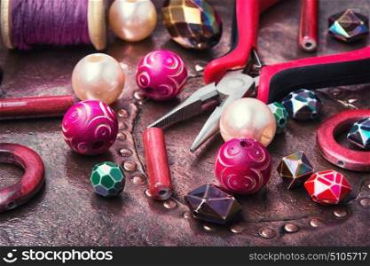Colorful beads and working tool. Making of handmade jewellery from colorful beads.Colorful bead heap