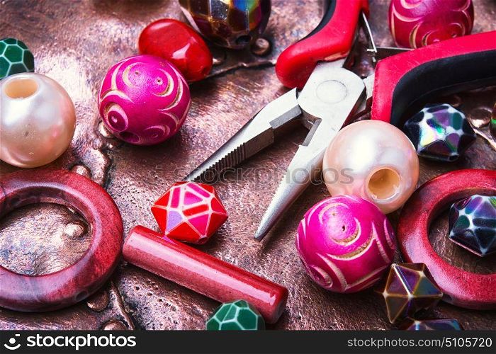 Colorful beads and working tool. Making of handmade jewellery from colorful beads.Colorful bead heap