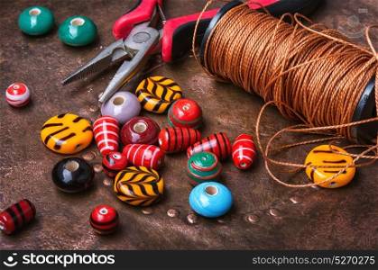 Colorful beads on wooden table