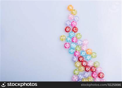 Colorful beads with letters isolated on a white background