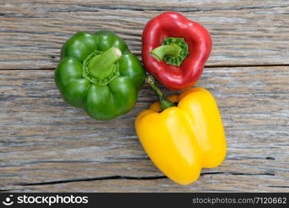 Colorful bell peppers on white wooden table. Top view