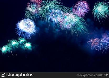 Colorful blue holiday fireworks on the black sky background