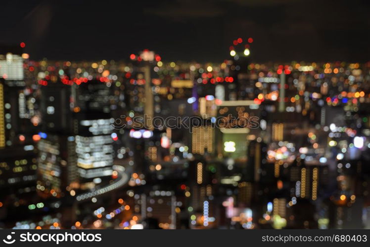 Colorful blurred aerial skyscrapers with city bokeh lights illuminated at night