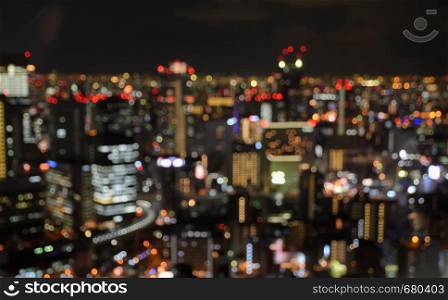 Colorful blurred aerial skyscrapers with city bokeh lights illuminated at night