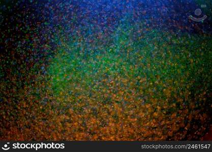 Colorful blurred drops shining on dark background