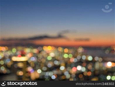 Colorful blurred skyline with city bokeh lights illuminated at sunset