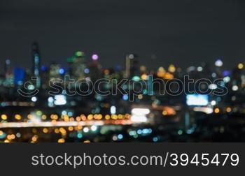 Colorful blurred skyscrapers with city bokeh lights illuminated at twilight