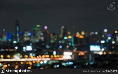 Colorful blurred skyscrapers with city bokeh lights illuminated at twilight