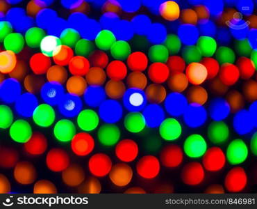 Colorful bokeh a defocus of light at night. Contrast of color warm and cool.