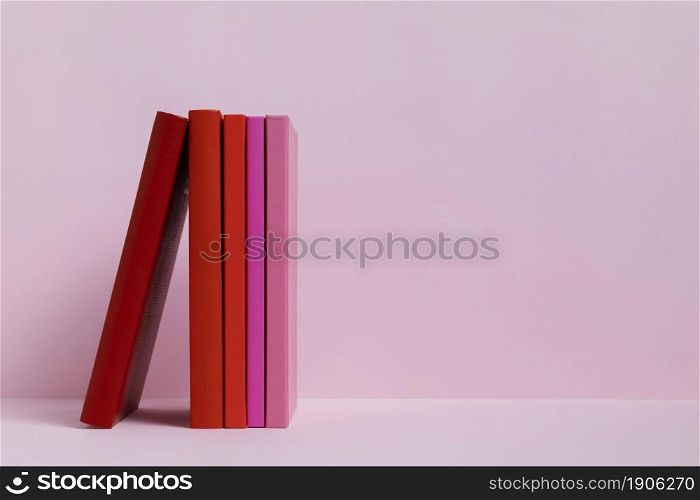 colorful books with pink background. High resolution photo. colorful books with pink background. High quality photo