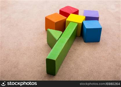 Colorful building blocks form a flower on a brown background