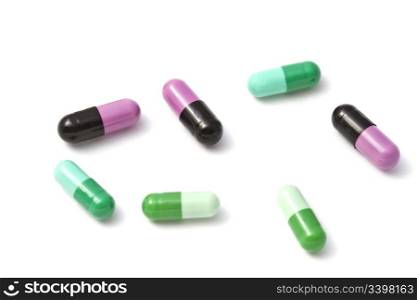 Colorful capsules closeup on white background