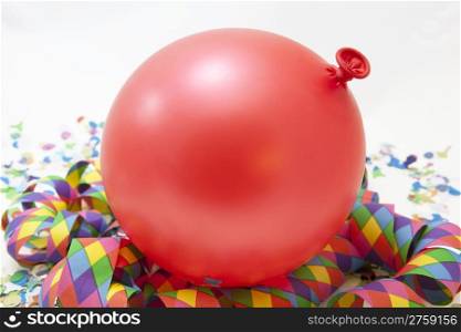 Colorful carnival background with stripes and red balloon