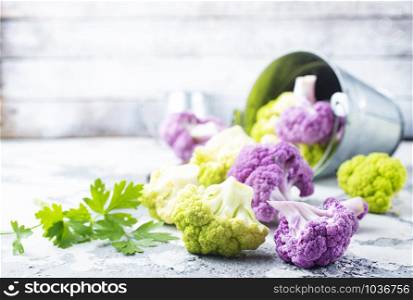 Colorful cauliflower cabbages on gray background. Healthy food