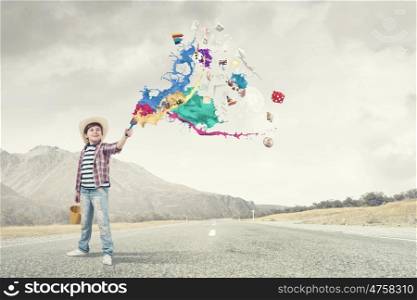 Colorful childhood. Boy of school age painting wall with brush