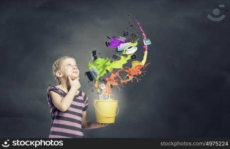 Colorful childhood!. Cute girl with bucket and colorful springs coming out