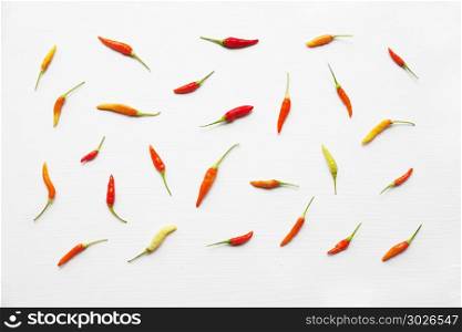 Colorful chili peppers on white.. Colorful chili peppers on white background.