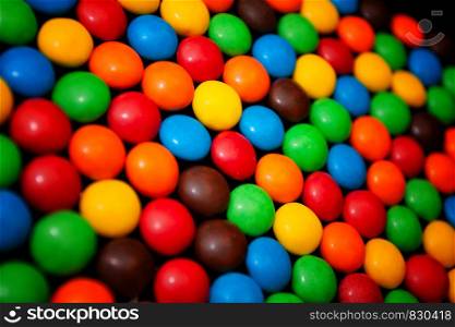 Colorful chocolate dragees for background. Colorful chewy dragees for background