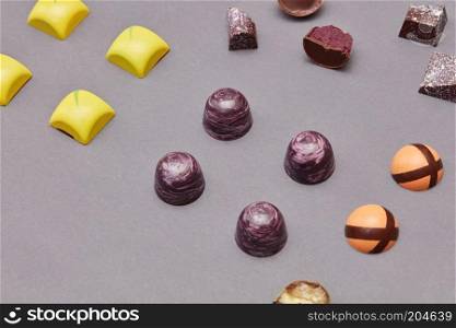 Colorful chocolates candies background isolated on brown.. Colorful candies background
