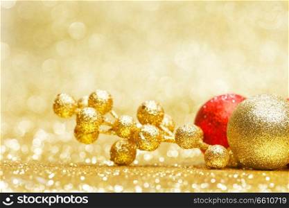 Colorful christmas decoration on shiny golden background