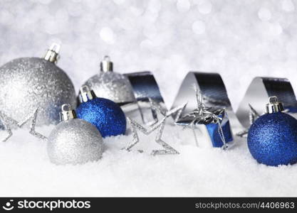 Colorful christmas decoration on snow close-up