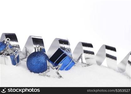 Colorful christmas decoration on snow close-up