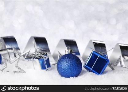 Colorful christmas decoration on snow close-up