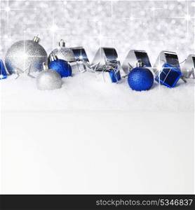 Colorful christmas decoration on snow over shiny stars background